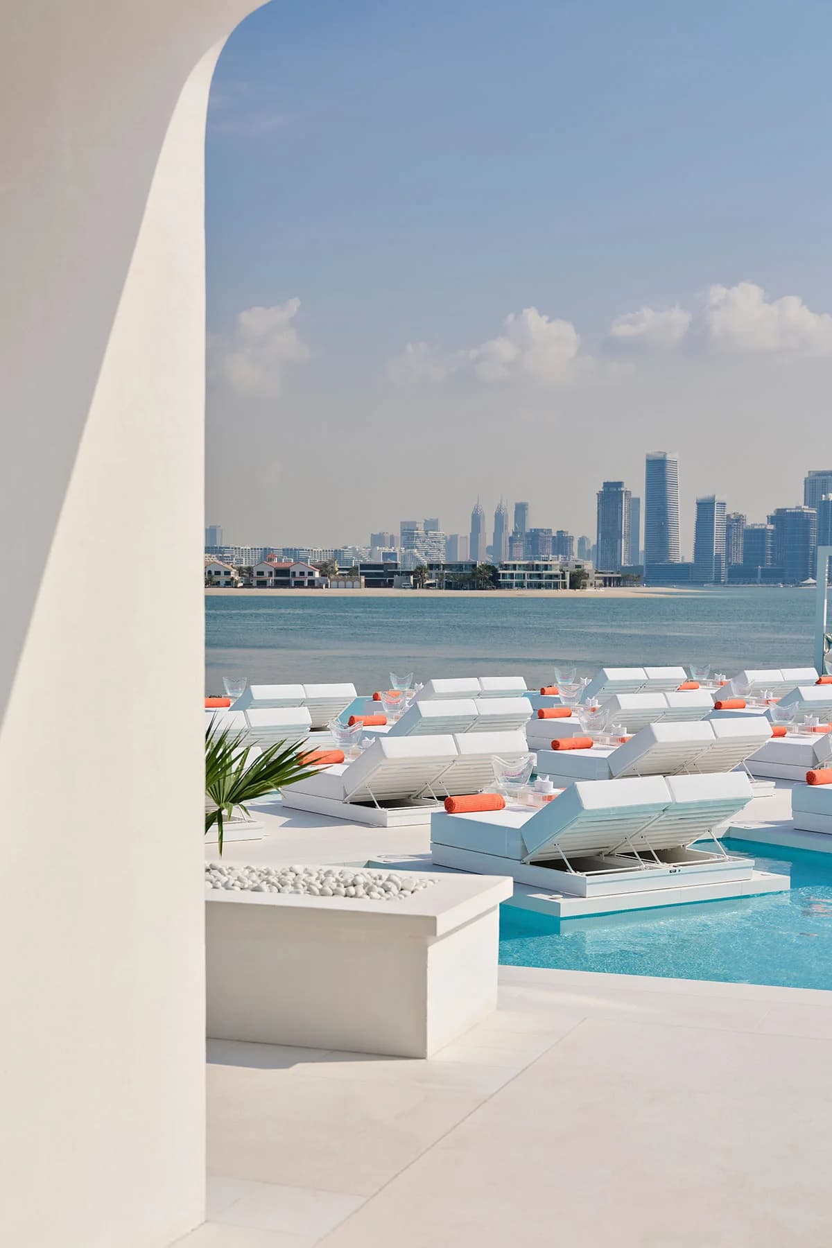 BCH CLB Dubai white pool loungers and skyline view from the Palm shoreline