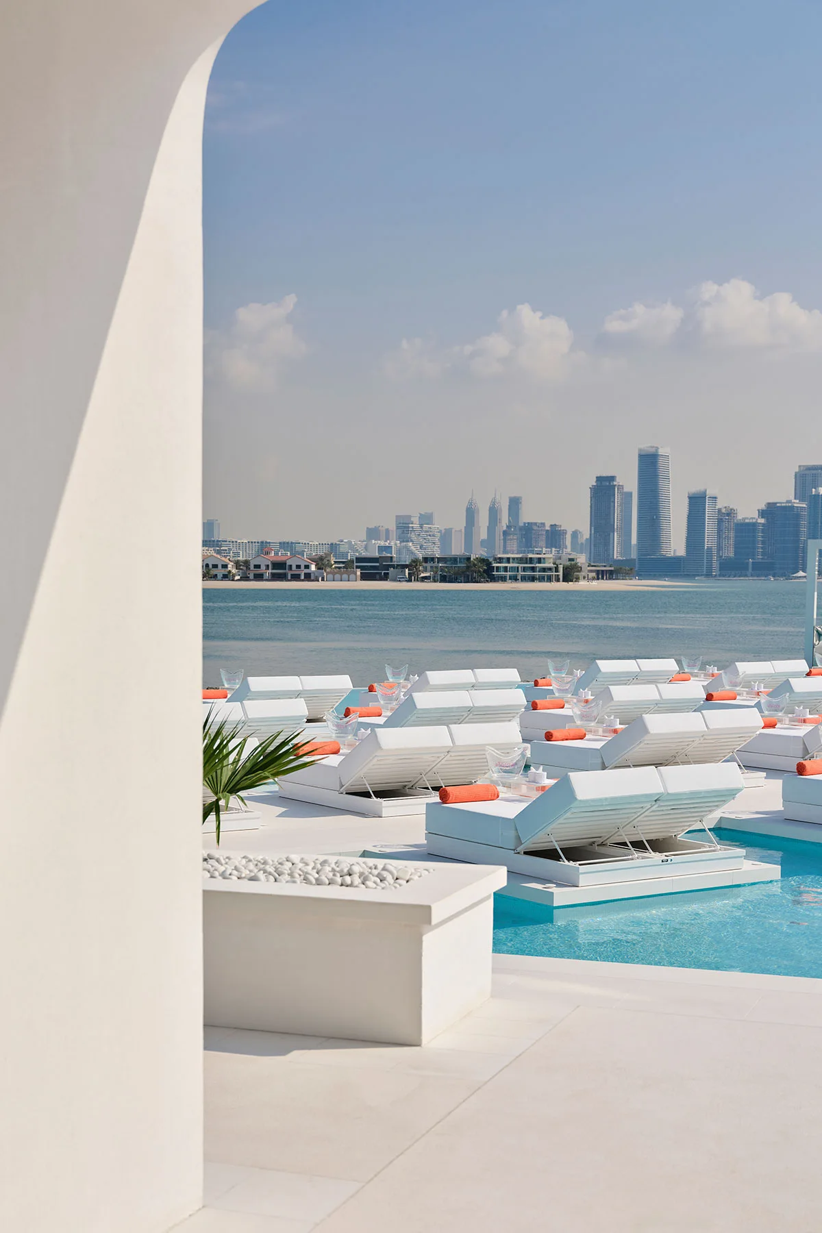BCH CLB Dubai white pool loungers and skyline view from the Palm shoreline
